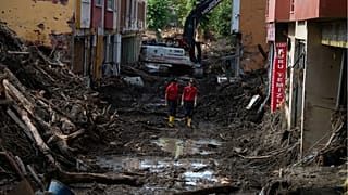 Rescue workers walk in a street in Bozkurt town of Kastamonu province.