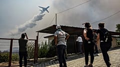 File photo of a plane pouring water over a fire-devastating village, near Manavgat, Antalya, Turkey