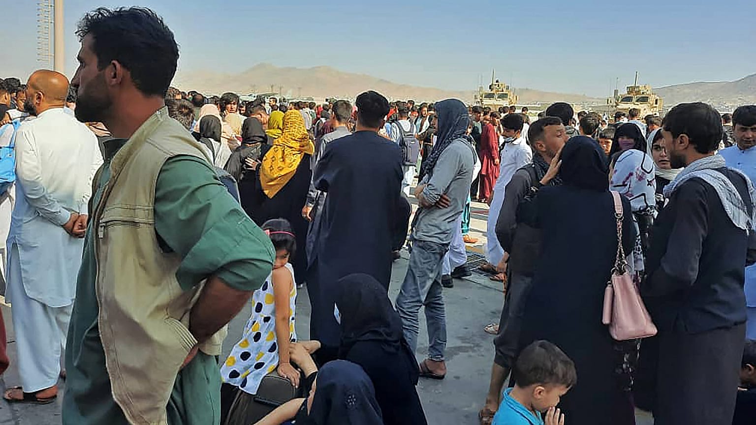 Afghans crowd at the tarmac of the Kabul airport