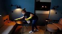 Un limpiadora de hotel prepara una habitación para los clientes