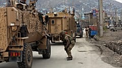 British soldiers with NATO-led Resolute Support Mission forces arrive at the site of an attack in Kabul, Afghanistan, Wednesday, March 25, 2020.