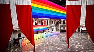 A rainbow flag is suspended at Copenhagen City Hall on Wednesday Aug. 11, 2021, marking the opening of Copenhagen 2021, World Pride and Eurogames