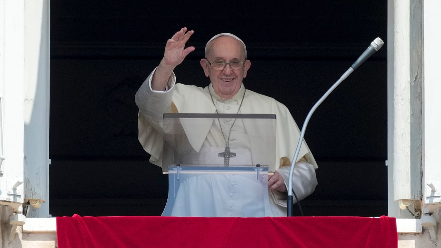 Pope Francis delivers his blessing as he recites the Angelus noon prayer from the window of his studio overlooking St.Peter's Square, at the Vatican, Aug. 15, 2021.