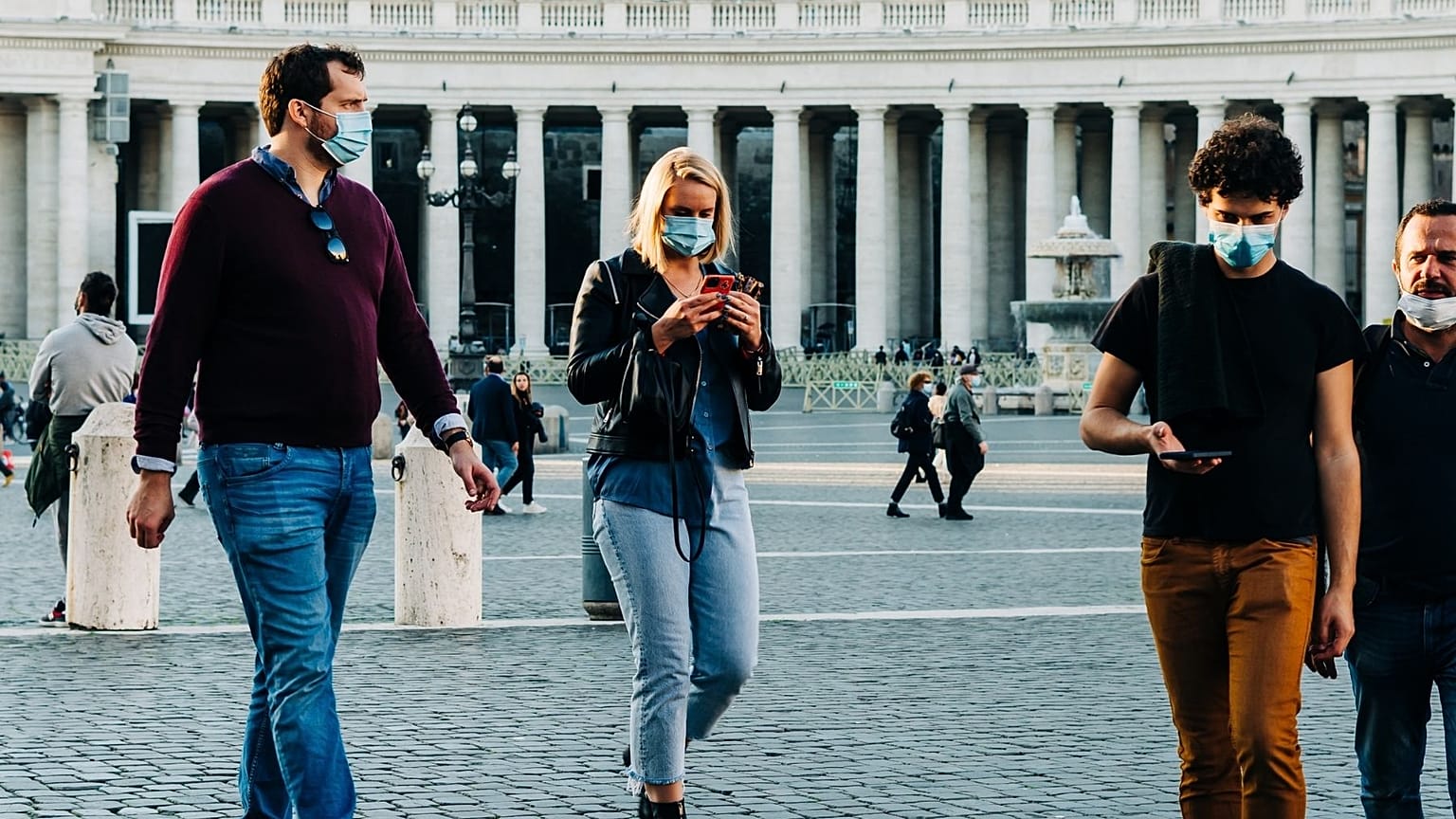 Tourists and locals wearing masks in outdoor spaces in Italy