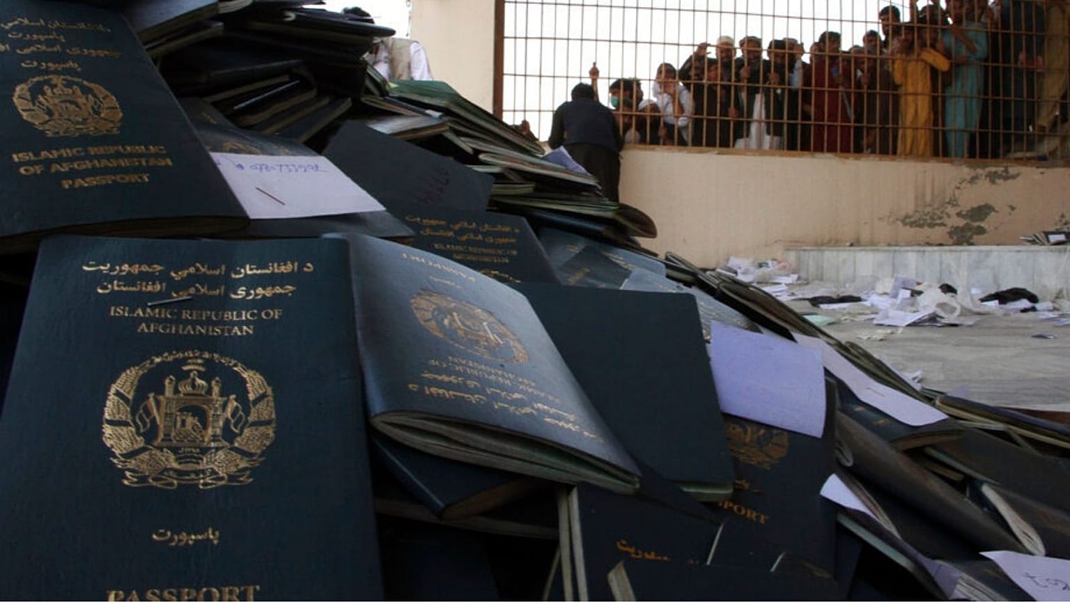 Afghans wait to collect their passports