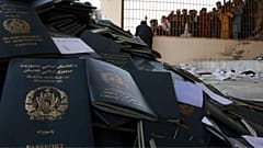 Afghans wait to collect their passports