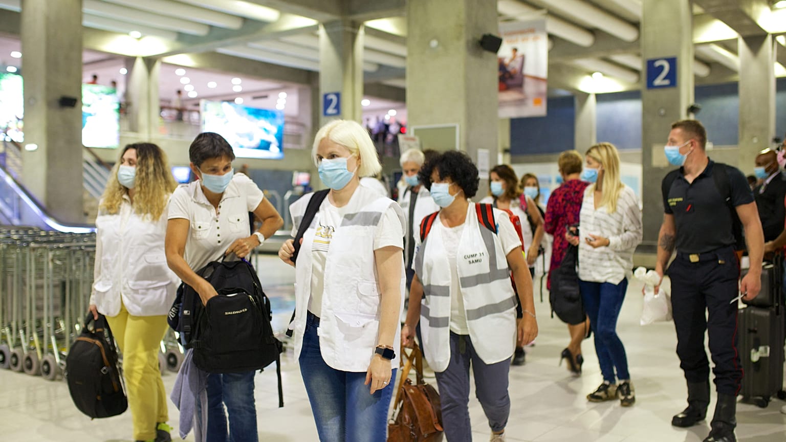 Emergency Medical Service staff arrive to the Pole Caraibes international airport in Pointe-a-Pitre on the French Caribbean archipelago of Guadeloupe, on August 10, 2021.