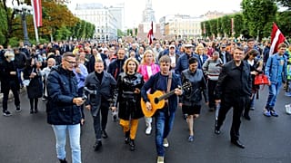 Protesters march during a protest against mandatory vaccinations, in Riga, Latvia