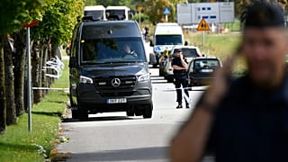 Police stand guard at the scene of an attack at a high school in Eslöv.