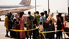Civilians prepare to board an evacuation plane out of Kabul Airport.