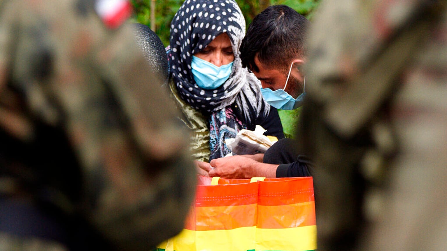 Some of the Afghans hoping to claim asylum in Poland, pictured after crossing the border on Thursday 