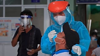 A medical worker takes swab sample from a man in Vung Tau city, Vietnam Saturday, Aug. 21, 2021. 