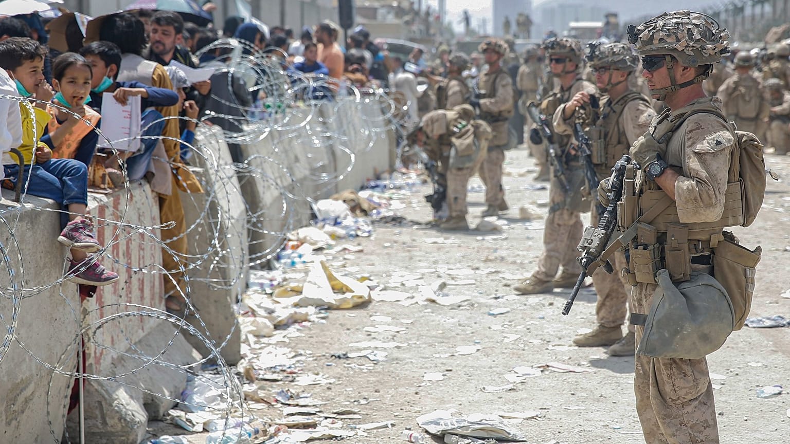 US marines provide assistance during an evacuation at Hamid Karzai International Airport in Kabul, Afghanistan, Friday, Aug. 20, 2021.