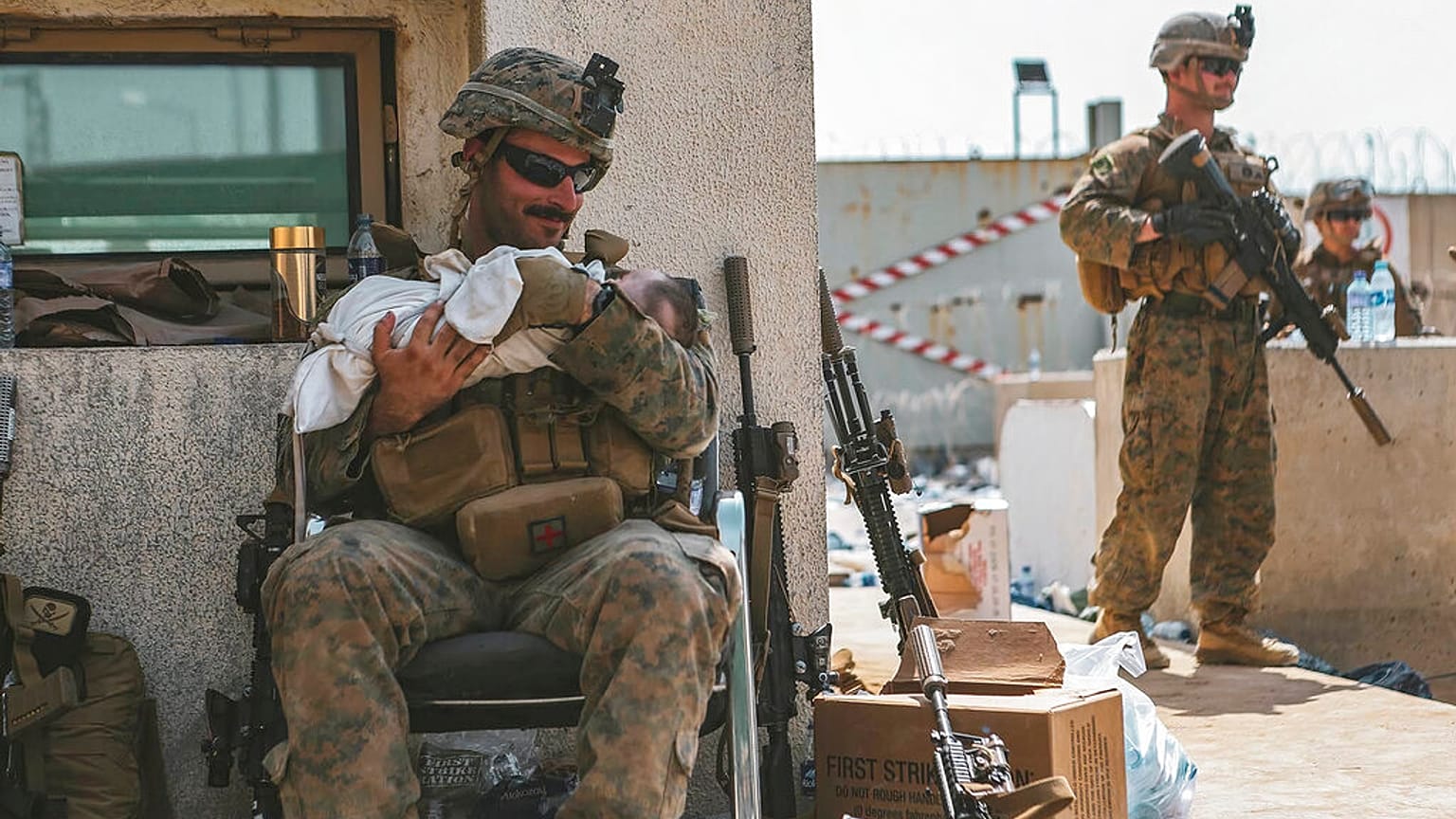 Ein US-Marine am Hamid-Karzai-Flughafen kümmert sich um ein afghanisches Baby