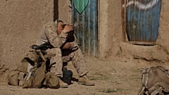 A U.S. Marine from 3rd Battalion, 6th Marine Regiment sits alone after a patrol in Marjah in Afghanistan's Helmand province Friday, Feb. 19, 2010.