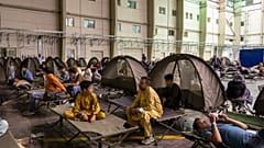 Refugees wait at an evacuation centre after they left Kabul as part of the operation "Apagan" at the French military air base of Al Dhafra, near Abu Dhabi, on August 23, 2021.