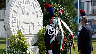 Italian Premier Mario Draghi pays his respects by a wreath on the monument in Amatrice.