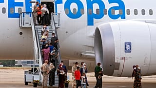 Afghan people who were transported from Afghanistan, disembark after landing at the Torrejon military base as part of the evacuation process in Madrid, Spain, August 24, 2021.
