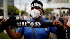A man sells badanas that reads "No to Bitcoin" in a war veterans protest to ask for better pensions and against the use of Bitcoin as legal tender in San Salvador, El Salvador