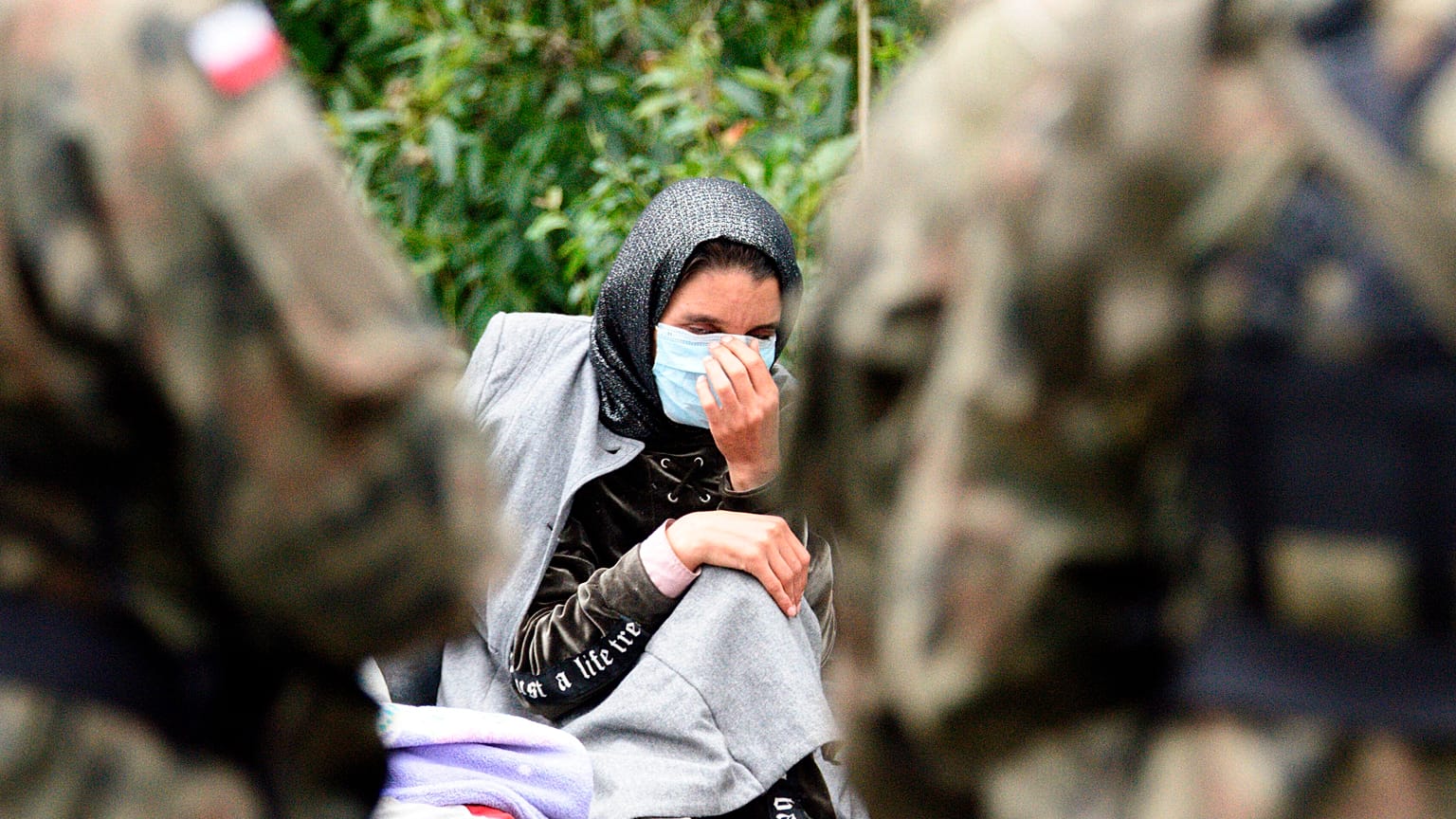 A migrant is pictured after crossing the border from Belarus into the village of Usnarz Gorny in Poland.
