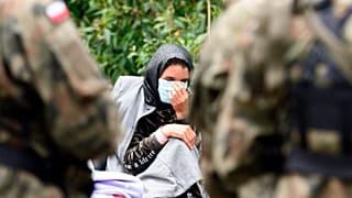 A migrant is pictured after crossing the border from Belarus into the village of Usnarz Gorny in Poland.