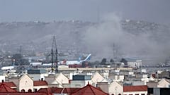 Smoke rises into the air after the explosion at Kabul airport on Thursday