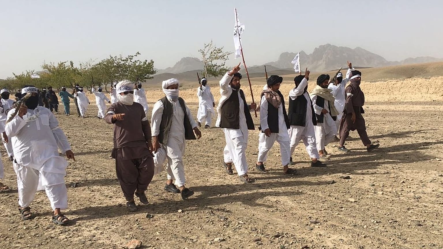 In this Monday, Aug. 15, 2016 photo, Mullah Emdadullah Mansoor, fifth left front, the new leader of the breakaway Taliban faction known as Mahaaz-e-Dadullah