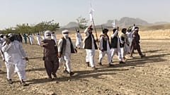 In this Monday, Aug. 15, 2016 photo, Mullah Emdadullah Mansoor, fifth left front, the new leader of the breakaway Taliban faction known as Mahaaz-e-Dadullah