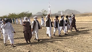 In this Monday, Aug. 15, 2016 photo, Mullah Emdadullah Mansoor, fifth left front, the new leader of the breakaway Taliban faction known as Mahaaz-e-Dadullah