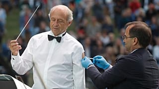 Ivan Fischer receives his third dose of the COVID-19 vaccine as he conducts the orchestra