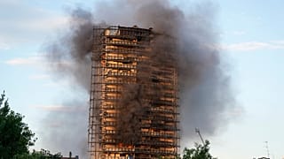 Smoke was still billowing from the 20-story residential building on Monday.