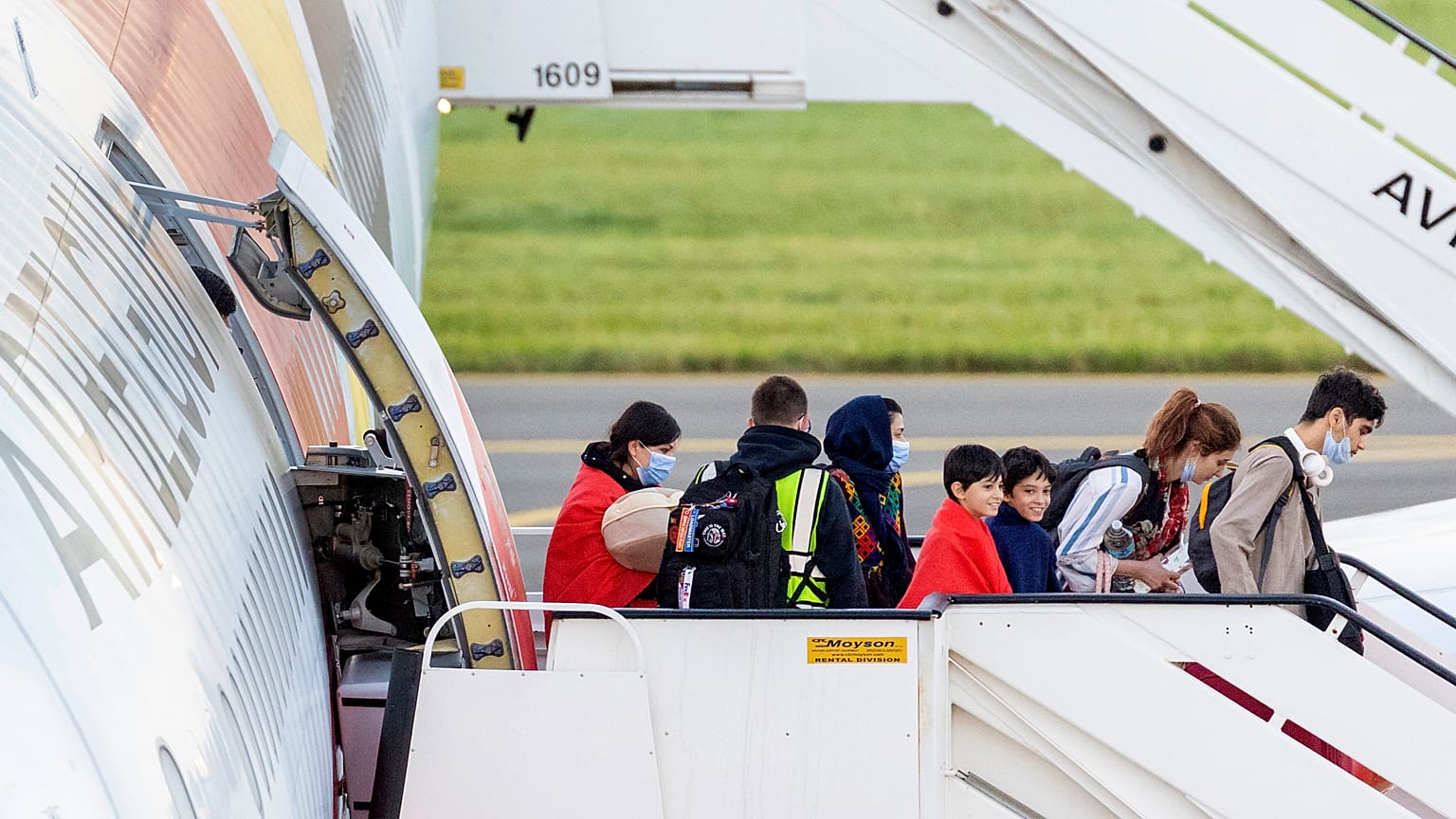 People disembark from an Air Belgium chartered plane, carrying passengers as part of an evacuation from Afghanistan, upon arrival in Belgium, Friday, Aug. 27, 2021.
