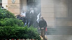 A group of pro-democracy activists in Poland seek to bloc the entrance of the constitutional court in an act of civil disobedience in Warsaw, Poland, on Monday Aug. 30, 2021