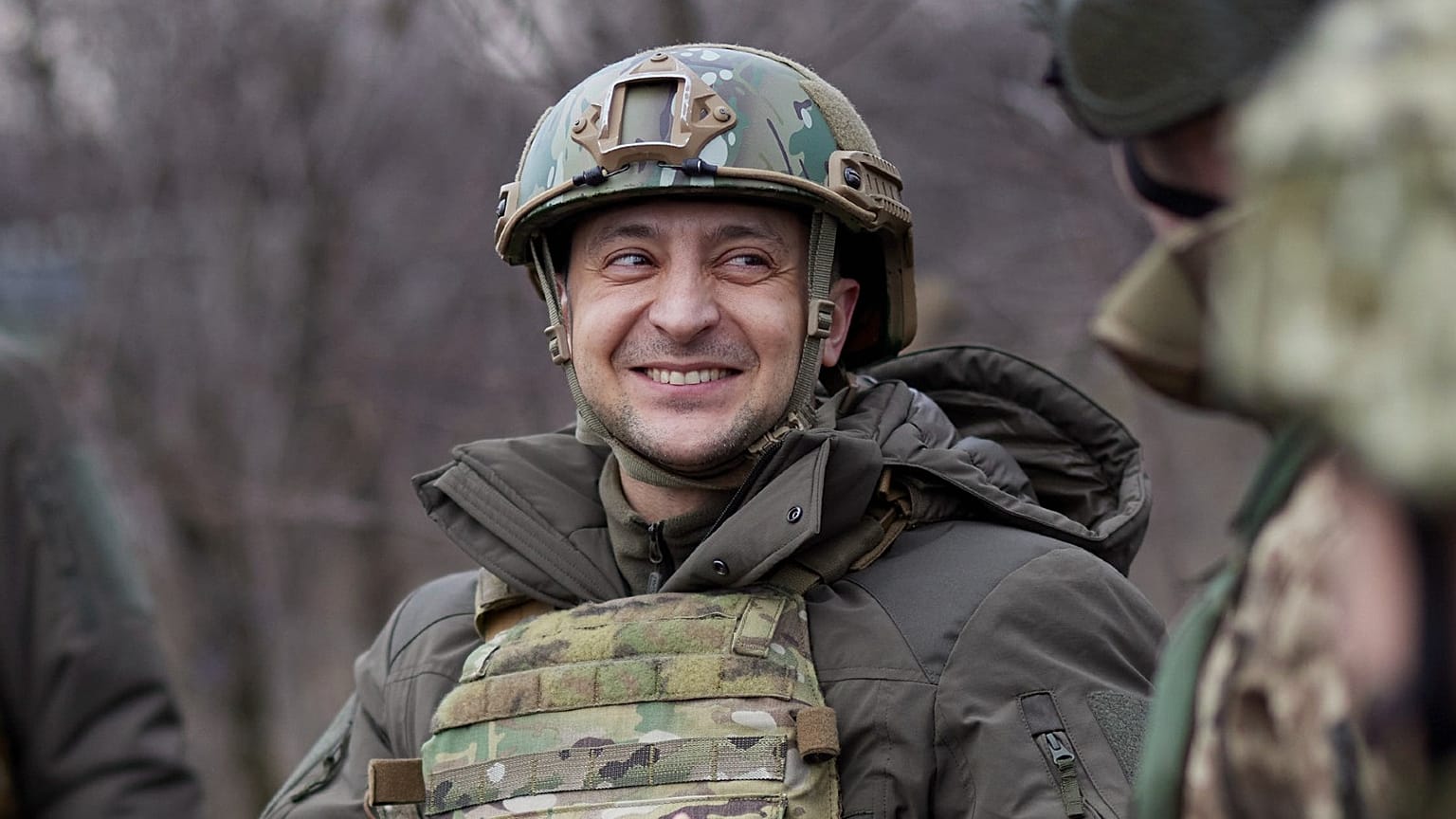 Ukrainian President Volodymyr Zelenskyy talks with servicemen as he visits the war-hit Donetsk region, eastern Ukraine, Feb. 11, 2021.