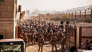US troops provide assistance during an evacuation at Hamid Karzai International Airport in Kabul