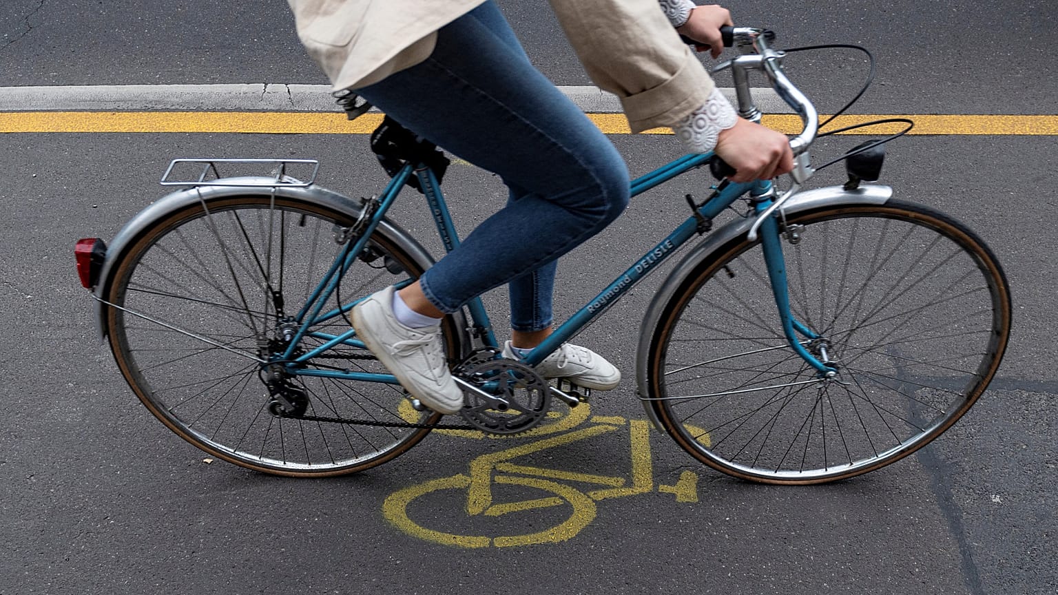 A woman cycles in a so-called pop-up cycling lane in Berlin on June 11, 2020