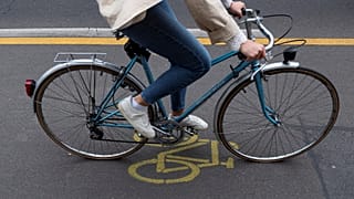 A woman cycles in a so-called pop-up cycling lane in Berlin on June 11, 2020