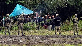 Polish security forces surround migrants stuck along with border with Belarus in Usnarz Gorny, Poland, on Wednesday, Sept. 1, 2021. 