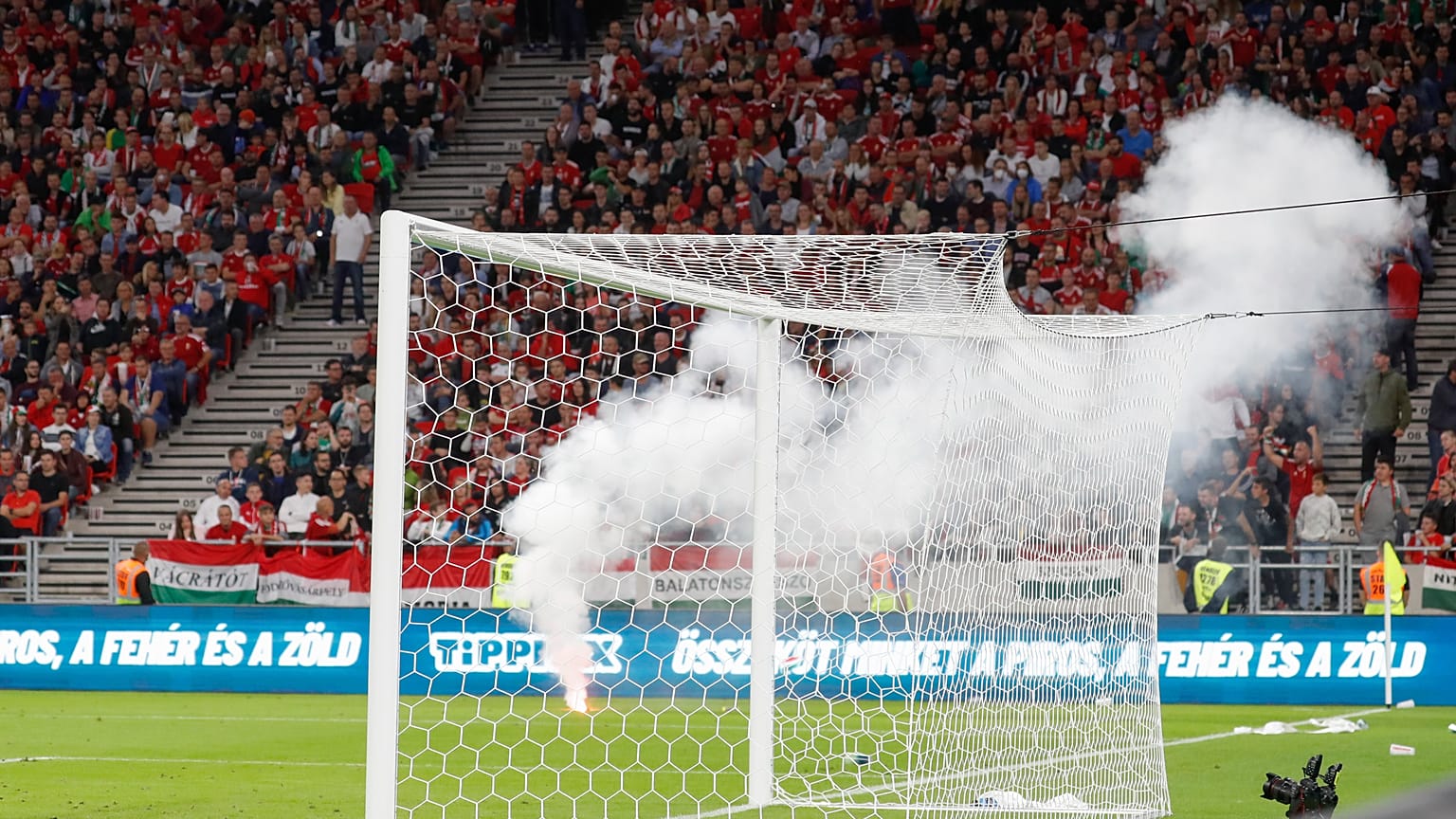 Players wait after a flare was thrown on the field during the World Cup 2022 qualifying match between Hungary and England, in Budapest, Hungary, Sept. 2, 2021.