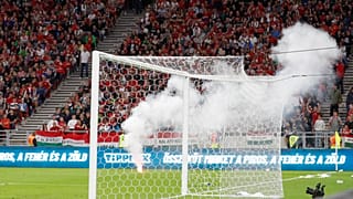 Players wait after a flare was thrown on the field during the World Cup 2022 qualifying match between Hungary and England, in Budapest, Hungary, Sept. 2, 2021.