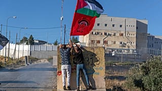 Palästinensische Demonstranten zeigen eine palästinensische Flagge