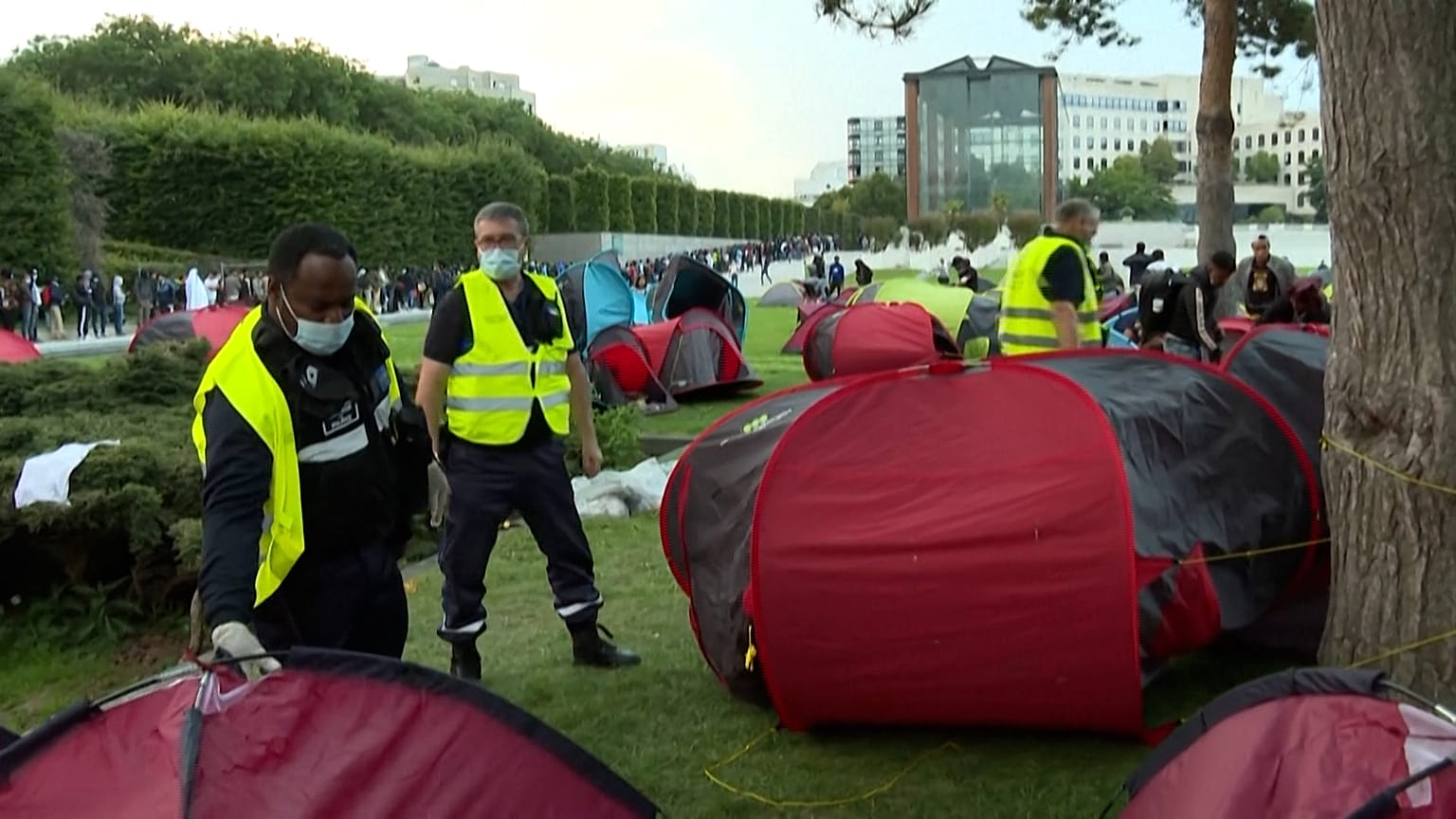 Officials checking if people are in tents.
