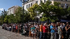 People wait outside the Athens Cathedral to pay respects to the late Greek composer Mikis Theodorakis in Athens on Monday Sept. 6, 2021.