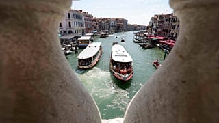 Public transport boats carrying tourists and citizens navigate along the Grand Canal, in Venice, Italy, Thursday, June 17, 2021.