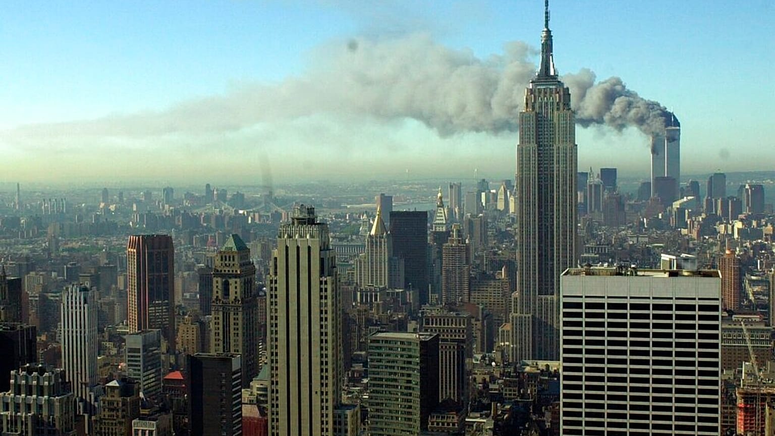 Smoke billows across the New York City skyline after two hijacked planes crashed into the twin towers on Sept. 11, 2001.
