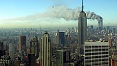 Smoke billows across the New York City skyline after two hijacked planes crashed into the twin towers on Sept. 11, 2001.
