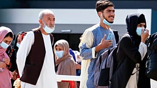 People evacuated from Afghanistan arrive at the Rome Leonardo da Vinci airport, Saturday, Aug. 28, 2021.