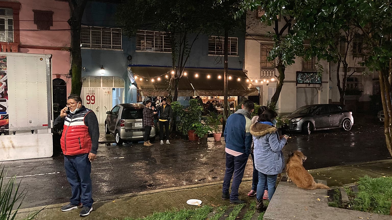 People gather outside on the sidewalk after a strong earthquake was felt, in the Roma neighbourhood of Mexico City, Tuesday, Sept. 7, 2021.
