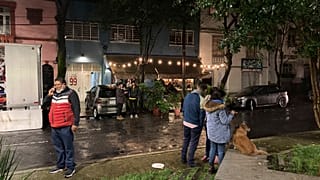 People gather outside on the sidewalk after a strong earthquake was felt, in the Roma neighbourhood of Mexico City, Tuesday, Sept. 7, 2021.