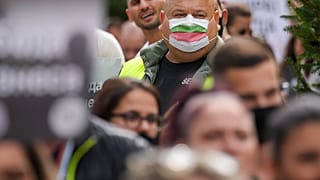A man wears a mask in the colours of the Bulgarian flag while attending a protest by restaurant workers in Veliko Tarnovo, Bulgaria, Thursday, Sept. 2, 2021. 